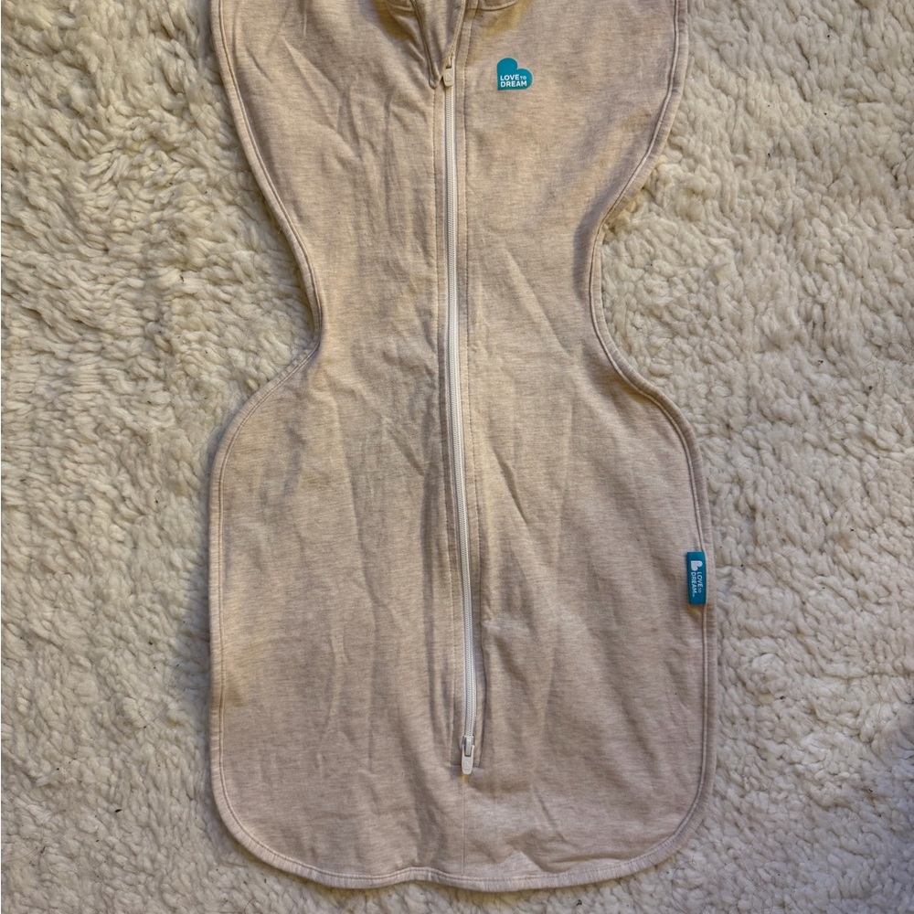 Love to Dream Stretch Cotton Swaddle in Cream with Teal Logo